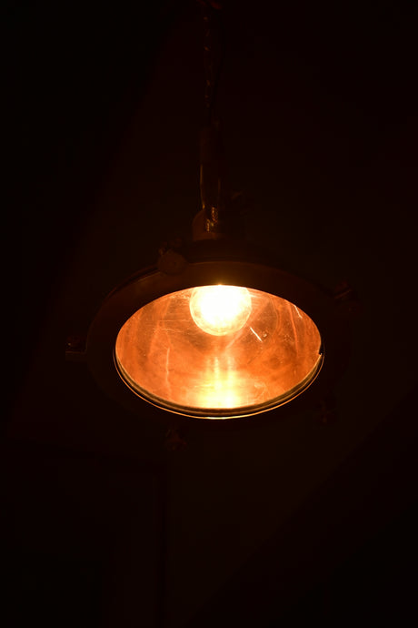 A light hanging from a ceiling in a dark room