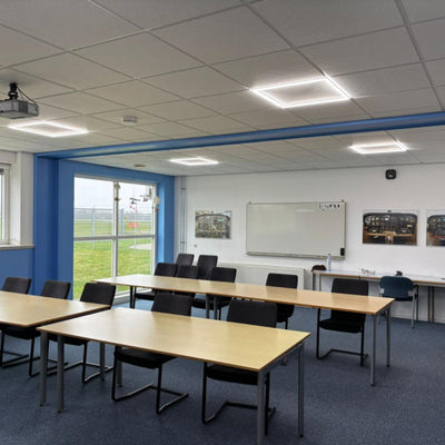 Dalles LED cadre au-dessus des tables dans une salle de cours
